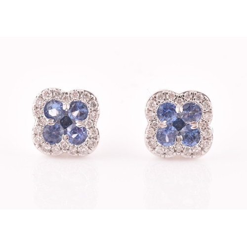 115 - A pair of 18ct white gold, diamond, and sapphire quatrefoil cluster earrings, each inset with five r... 