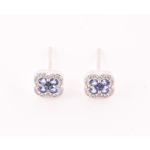 115 - A pair of 18ct white gold, diamond, and sapphire quatrefoil cluster earrings, each inset with five r... 