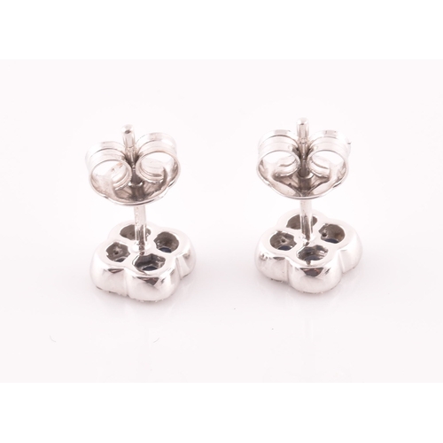 115 - A pair of 18ct white gold, diamond, and sapphire quatrefoil cluster earrings, each inset with five r... 