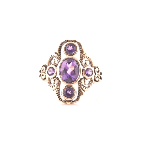 116 - A 9ct yellow gold and amethyst dress ring, the stylised openwork mount bezel set with a mixed oval-c... 