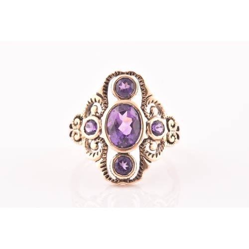 116 - A 9ct yellow gold and amethyst dress ring, the stylised openwork mount bezel set with a mixed oval-c... 