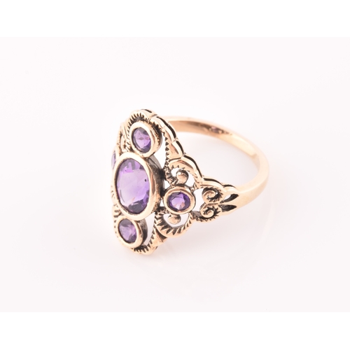 116 - A 9ct yellow gold and amethyst dress ring, the stylised openwork mount bezel set with a mixed oval-c... 