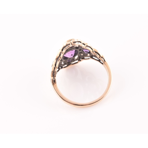 116 - A 9ct yellow gold and amethyst dress ring, the stylised openwork mount bezel set with a mixed oval-c... 