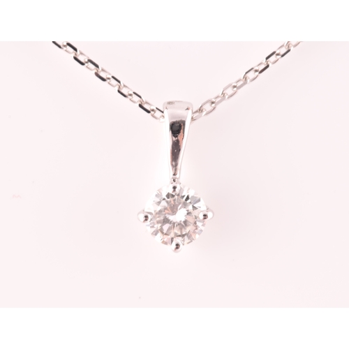 117 - A 9ct white gold mounted solitaire diamond pendant, of approximately 0.30 carats, suspended on a 9ct... 