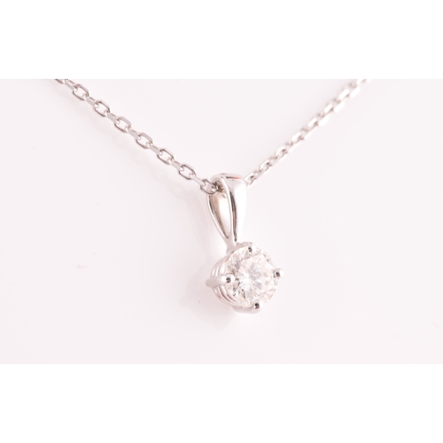 117 - A 9ct white gold mounted solitaire diamond pendant, of approximately 0.30 carats, suspended on a 9ct... 