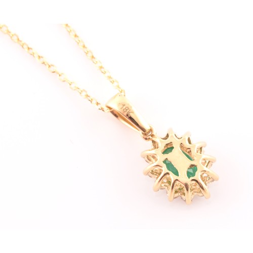 118 - An 18ct yellow gold, diamond, and emerald cluster pendant, set with a mixed oval-cut emerald, within... 