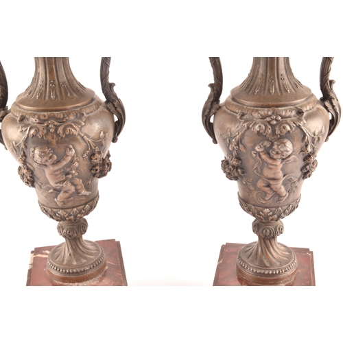 305 - A pair of Victorian spelter garniture urns, decorated with cherubs and garlands of flowers, with scr... 