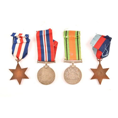 313 - A group of four WWII Medals comprising: a 1939-45 War Medal; a Defence Medal; a 1939-1945 Star and a... 