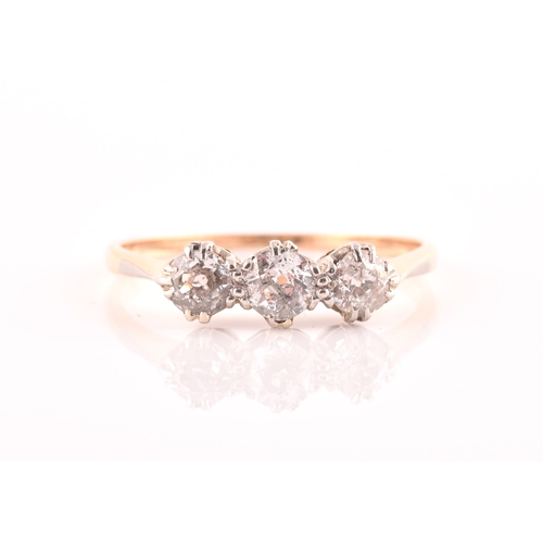 61 - A yellow metal and diamond ring, set with three transitional-cut diamonds of approximately 0.60 cara... 