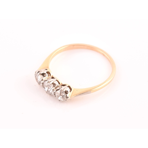 61 - A yellow metal and diamond ring, set with three transitional-cut diamonds of approximately 0.60 cara... 