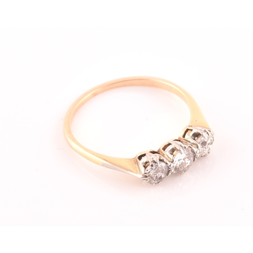 61 - A yellow metal and diamond ring, set with three transitional-cut diamonds of approximately 0.60 cara... 