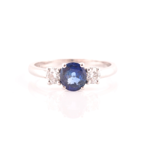 62 - An 18ct white gold, diamond, and sapphire ring, set with a mixed round-cut blue sapphire, flanked wi... 