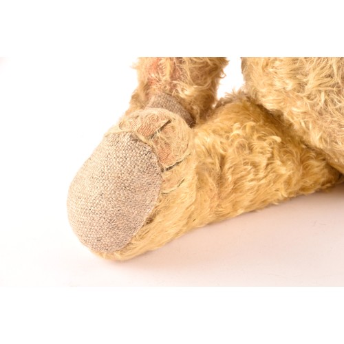 308 - A large 1920s mohair teddy bear, ‘Bruin’, with articulated head, legs and arms. 60 cm long.