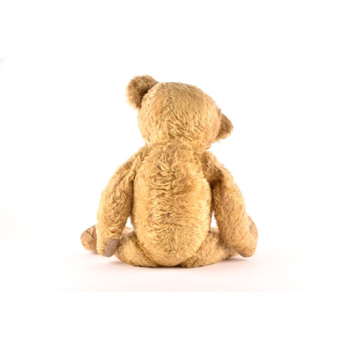 308 - A large 1920s mohair teddy bear, ‘Bruin’, with articulated head, legs and arms. 60 cm long.