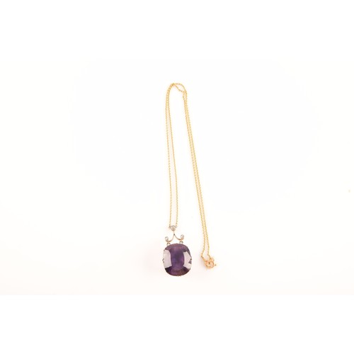 87 - A 15ct yellow gold and silver pendant and chain set with a cushion shape mixed cut amethyst with an ... 