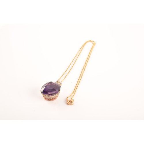 87 - A 15ct yellow gold and silver pendant and chain set with a cushion shape mixed cut amethyst with an ... 