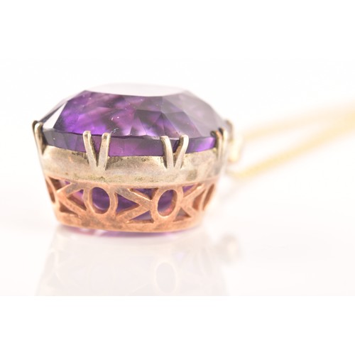 87 - A 15ct yellow gold and silver pendant and chain set with a cushion shape mixed cut amethyst with an ... 