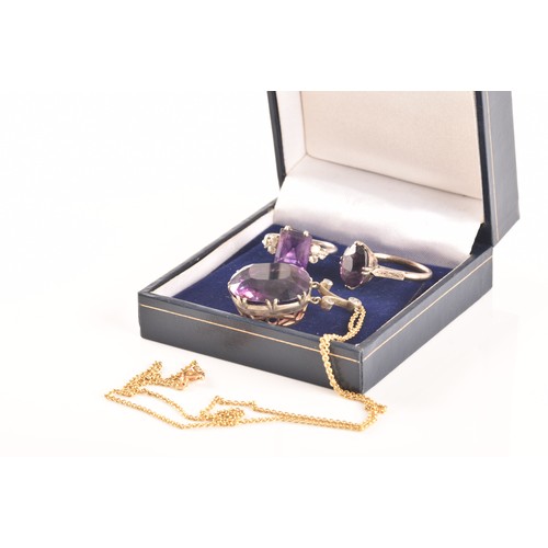 87 - A 15ct yellow gold and silver pendant and chain set with a cushion shape mixed cut amethyst with an ... 