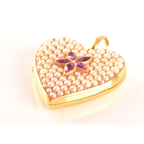 65 - A 18ct yellow gold heart locket pendant set to centre with four rubies with an combined approximate ... 