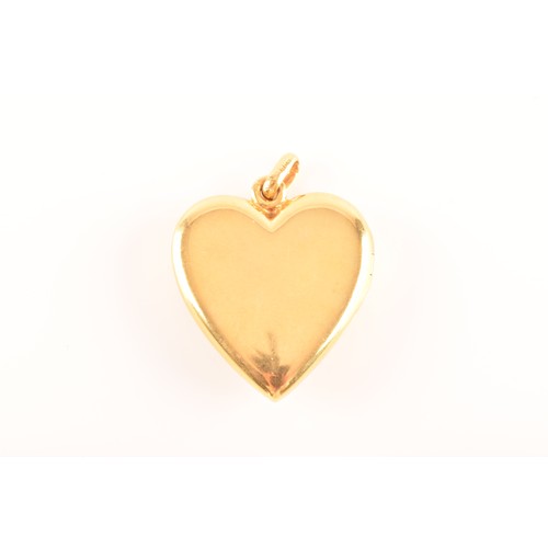 65 - A 18ct yellow gold heart locket pendant set to centre with four rubies with an combined approximate ... 