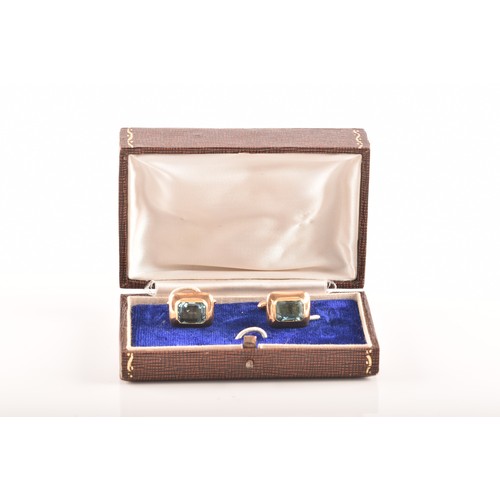 72 - A pair of yellow gold and aquamarine cufflinks set with two mixed cut aquamarines with a combined ap... 