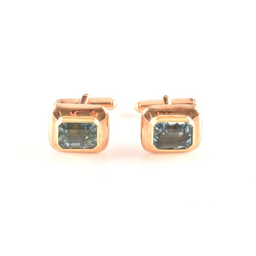 72 - A pair of yellow gold and aquamarine cufflinks set with two mixed cut aquamarines with a combined ap... 