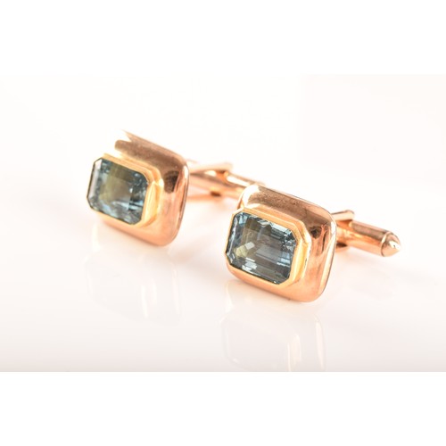 72 - A pair of yellow gold and aquamarine cufflinks set with two mixed cut aquamarines with a combined ap... 