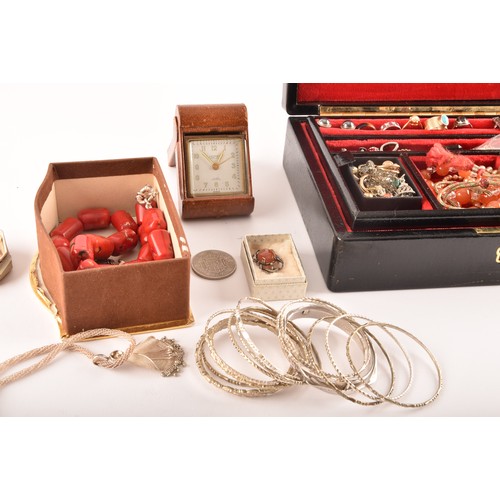 75 - A group of costume jewellery including a rose metal and opal ring, gold metal charms and studs, a pe... 