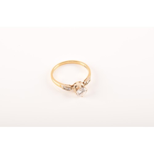 37 - A 18 carat yellow gold diamond solitaire, set to centre with a round brilliant cut diamond with an a... 