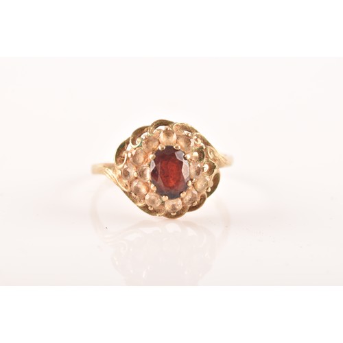 43 - A small group of gold rings, including a 9ct yellow gold garnet and paste ring, featuring full hallm... 