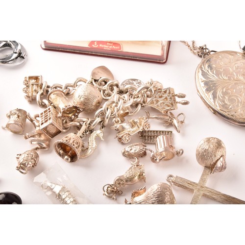 54 - A large collection of costume jewellery and miscellaneous items to include, a silver charm bracelet,... 