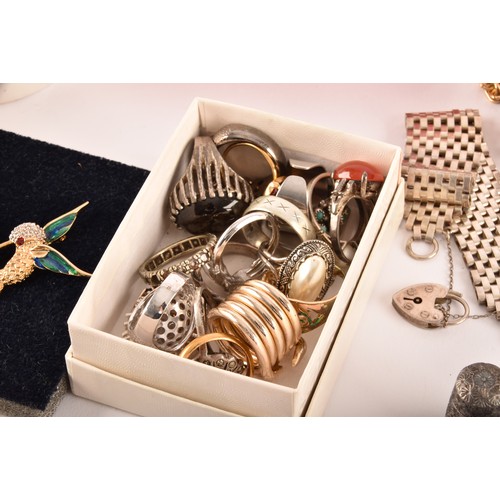 54 - A large collection of costume jewellery and miscellaneous items to include, a silver charm bracelet,... 