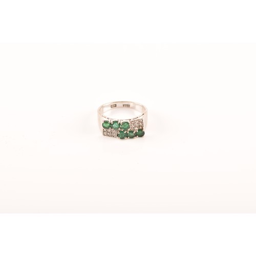 55 - A 18ct white gold ring, set with six emeralds with an approximate combined weight of 0.50 carats, su... 