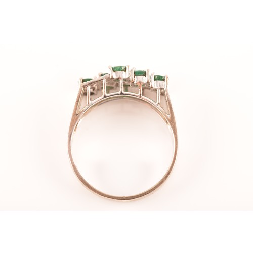 55 - A 18ct white gold ring, set with six emeralds with an approximate combined weight of 0.50 carats, su... 