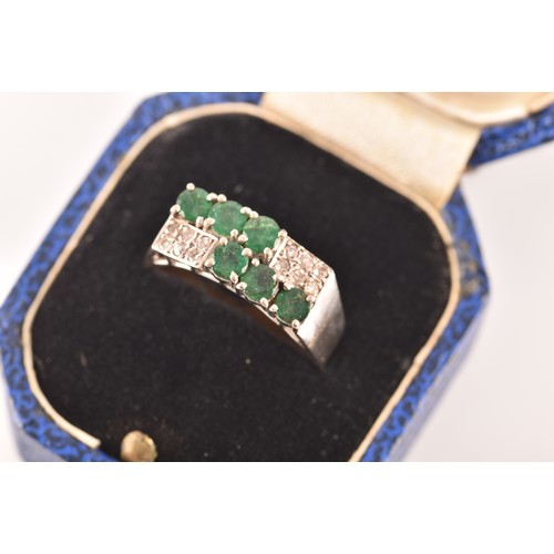 55 - A 18ct white gold ring, set with six emeralds with an approximate combined weight of 0.50 carats, su... 