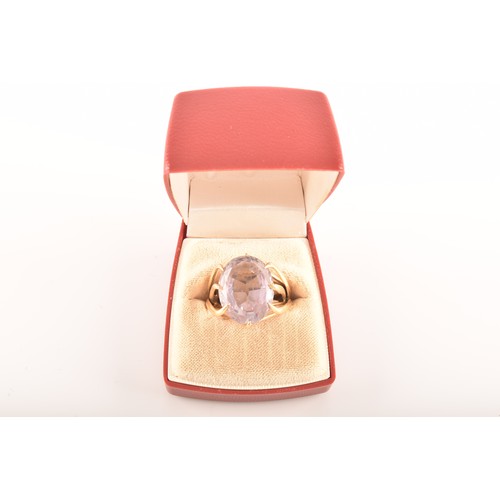 56 - A yellow metal cocktail ring set with an amethyst with an approximate weight of 13.00 carats, size N... 