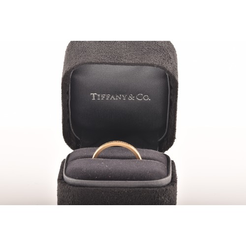 7 - Tiffany & Co. A Lucida 18ct yellow gold diamond half eternity ring, set with 17 brilliant cut di... 