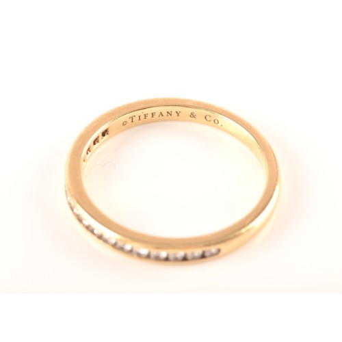 7 - Tiffany & Co. A Lucida 18ct yellow gold diamond half eternity ring, set with 17 brilliant cut di... 