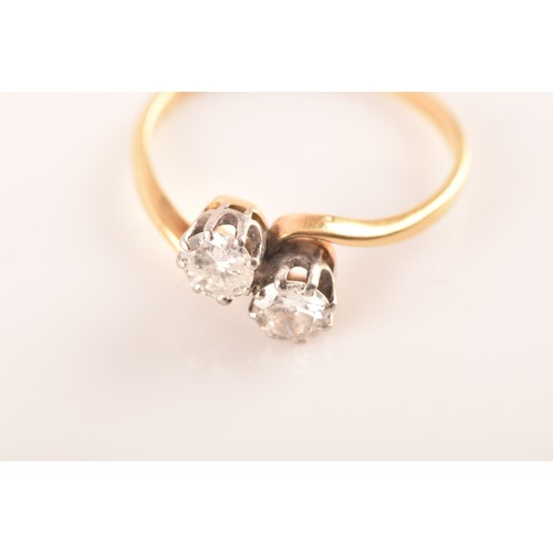 9 - A 18ct yellow gold and platinum two stone ring, set with two brilliant cut diamonds, approximately I... 