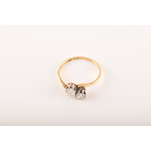 9 - A 18ct yellow gold and platinum two stone ring, set with two brilliant cut diamonds, approximately I... 