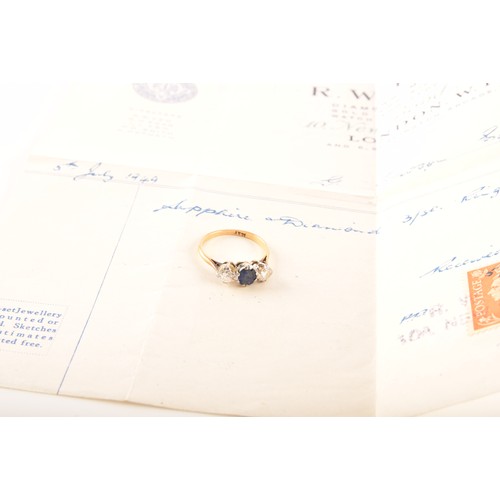 57 - An 18ct yellow gold three stone sapphire and diamond ring, set to centre with an oval sapphire with ... 