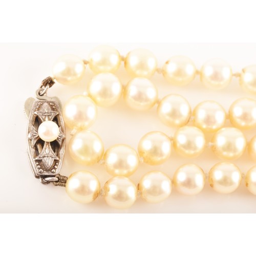 58 - A pearl necklace with silver metal decorated clasp, approximately 8 inches in length, a 9ct yellow g... 