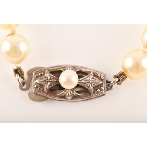 58 - A pearl necklace with silver metal decorated clasp, approximately 8 inches in length, a 9ct yellow g... 