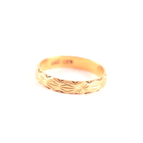 47 - A yellow gold engraved wedding band, size K, along with a yellow metal pin brooch, measuring approxi... 