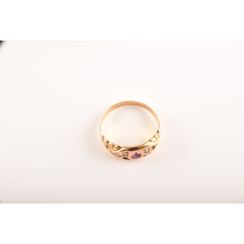 48 - A Victorian 15ct yellow gold ring featuring a ruby to the centre, surrounded by seed pearls, size N,... 