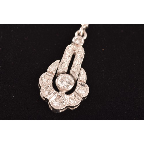 29 - An 18ct white gold drop pendant, featuring a brilliant cut diamond to the centre with an approximate... 