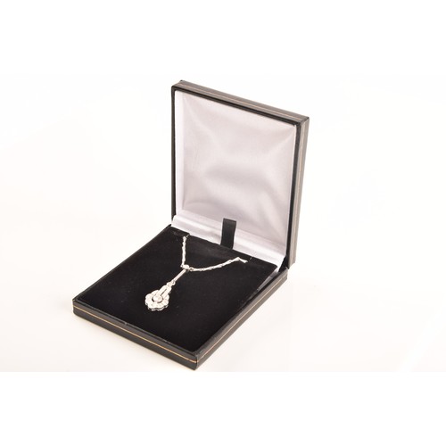 29 - An 18ct white gold drop pendant, featuring a brilliant cut diamond to the centre with an approximate... 