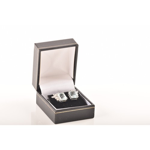 23 - A pair of 18ct white gold and platinum earrings, each featuring an octagonal step cut aquamarine wit... 