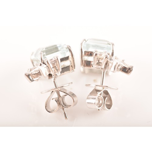 23 - A pair of 18ct white gold and platinum earrings, each featuring an octagonal step cut aquamarine wit... 