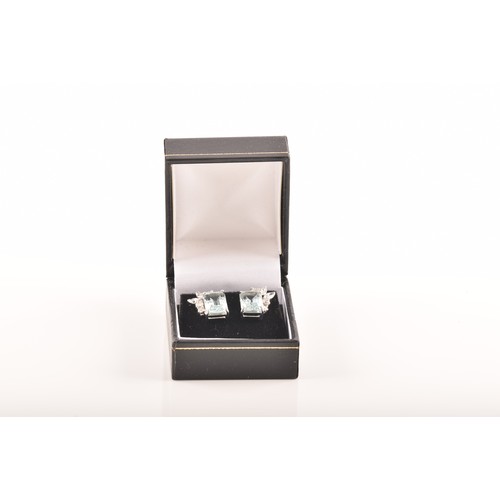 23 - A pair of 18ct white gold and platinum earrings, each featuring an octagonal step cut aquamarine wit... 